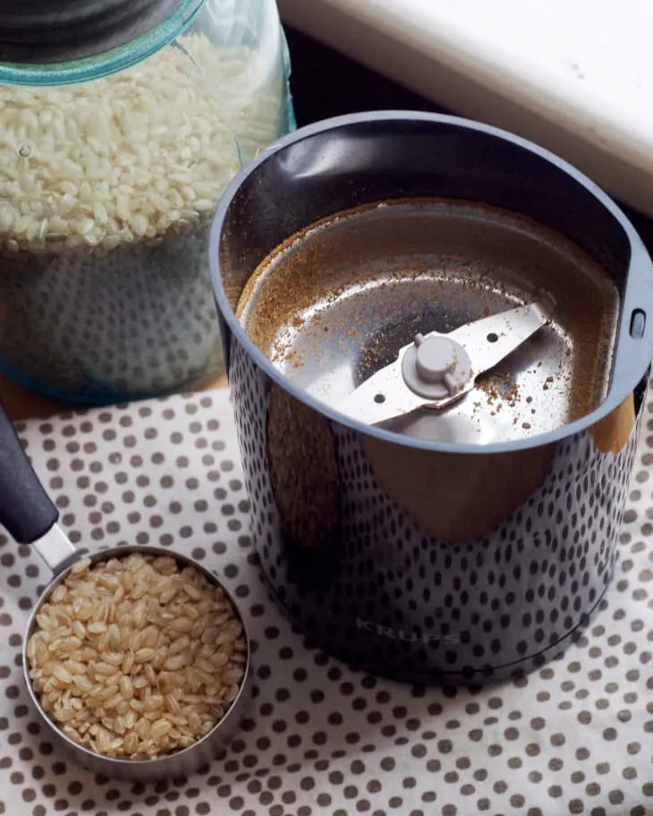 How to Clean a Coffee Grinder: A Simple Step-by-Step Guide Carefully cleaning the metal burrs of a coffee grinder with a soft brush.