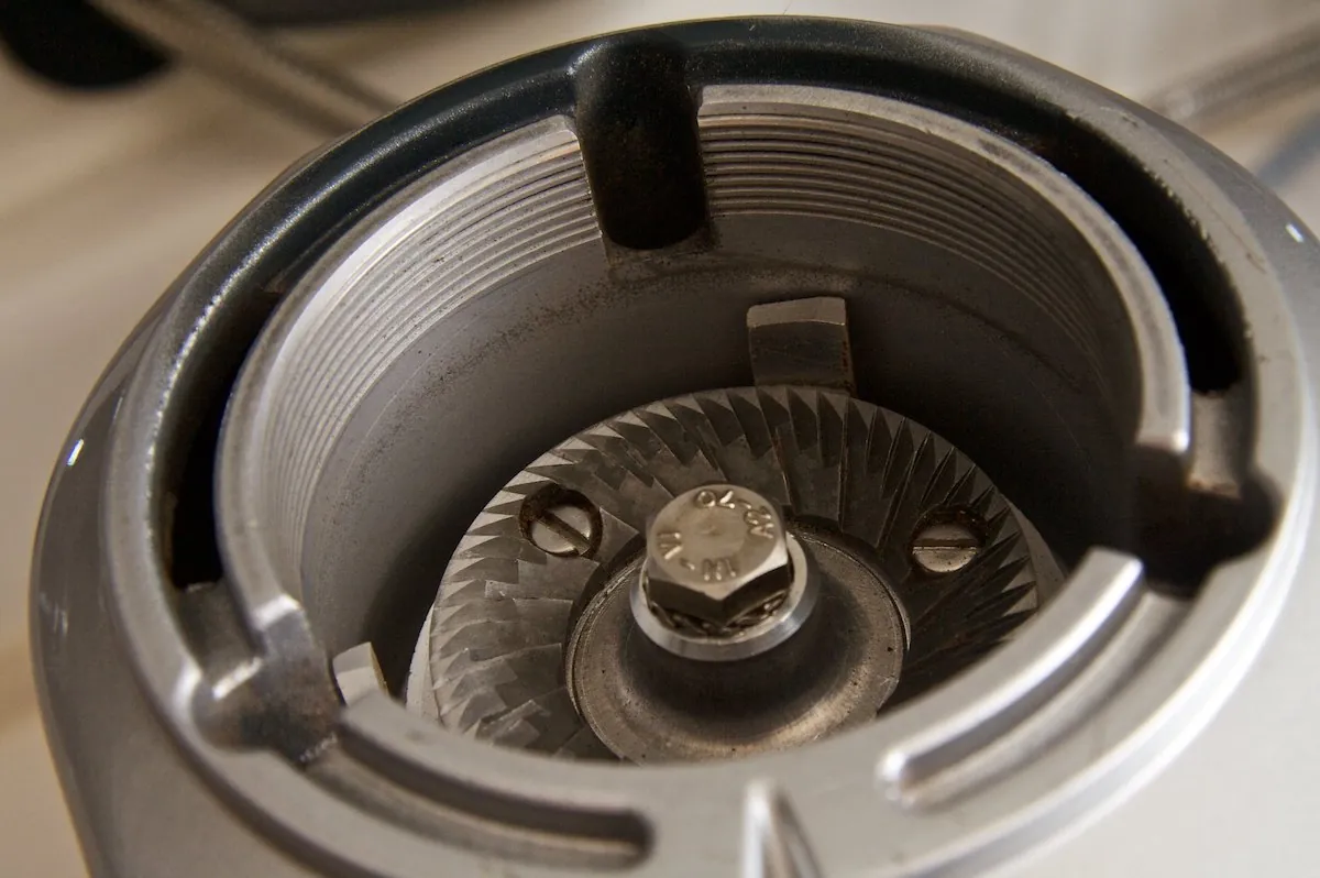 How to Clean Coffee Grinder Burrs: A Step-by-Step Guide A coffee grinder sits next to a bowl of rice for cleaning.