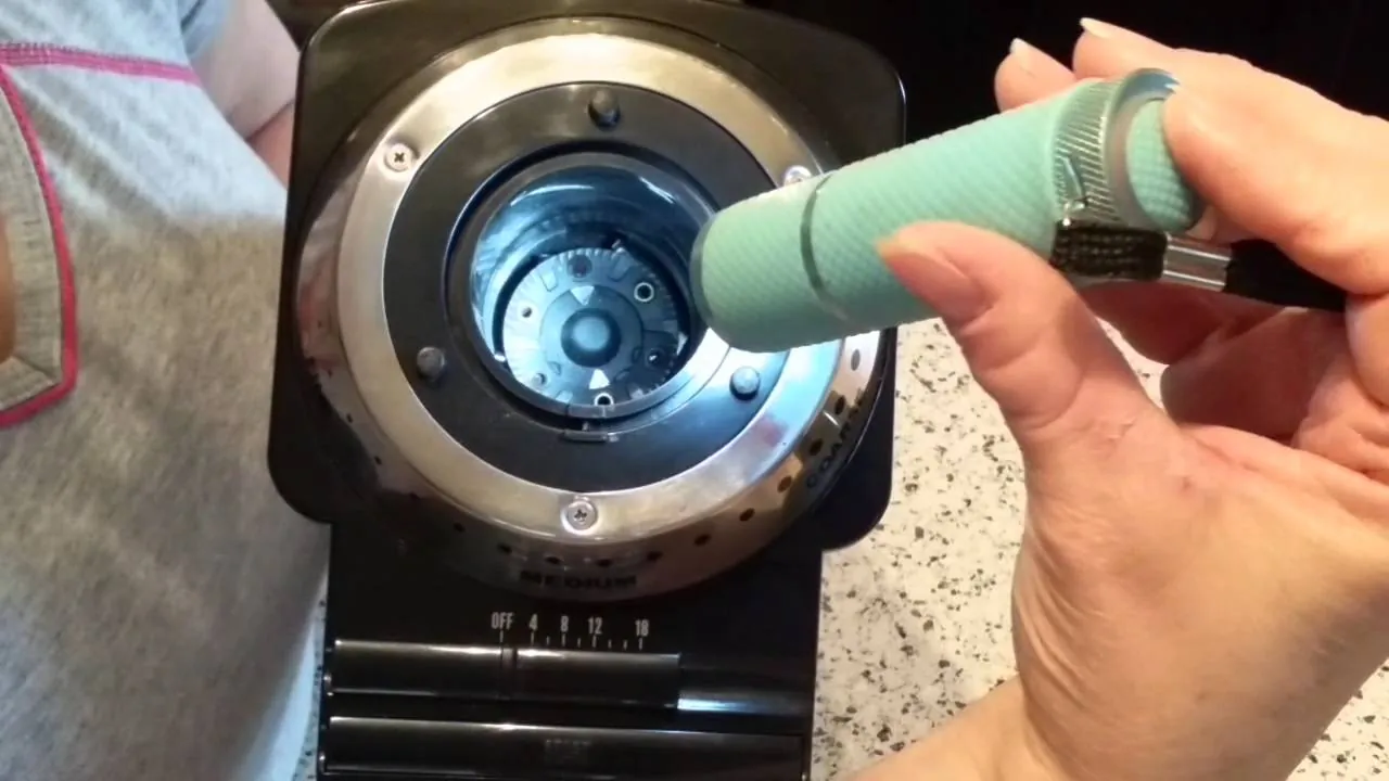 How to Clean a Cuisinart Coffee Grinder: Simple Routine Disassembled coffee grinder burr parts laid out on a clean white cloth.
