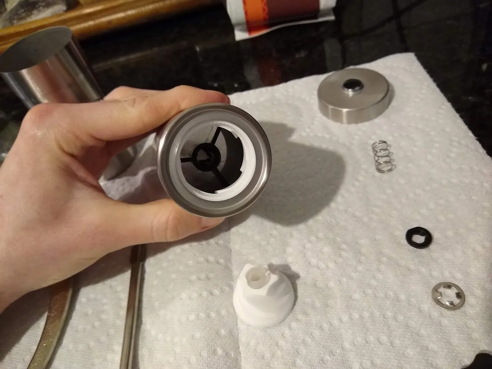How to Clean a Coffee Grinder: A Simple Step-by-Step Guide Essential cleaning supplies for a coffee grinder arranged on a white marble surface.